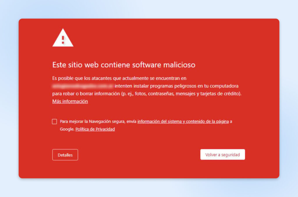Una ventana emergente roja muestra la advertencia "El sitio siguiente contiene malware".