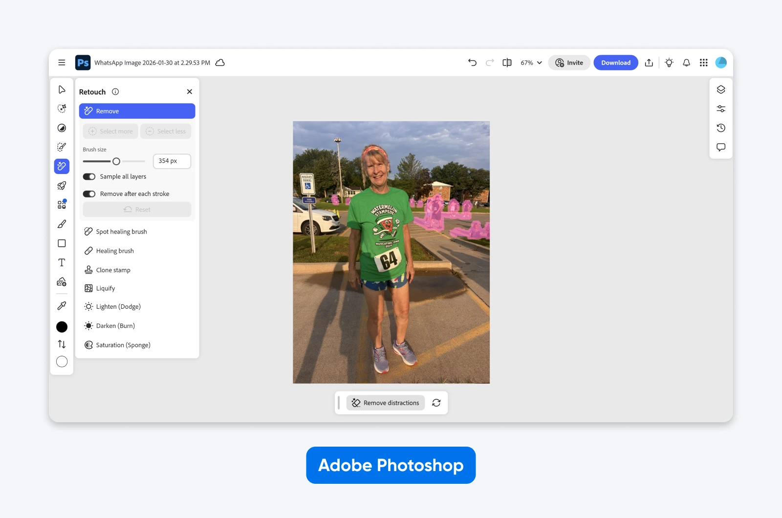 Adobe Photoshop interface using the Retouch tool to remove background distractions from a photo of a smiling woman in a green “Watermelon Stampede” race shirt.